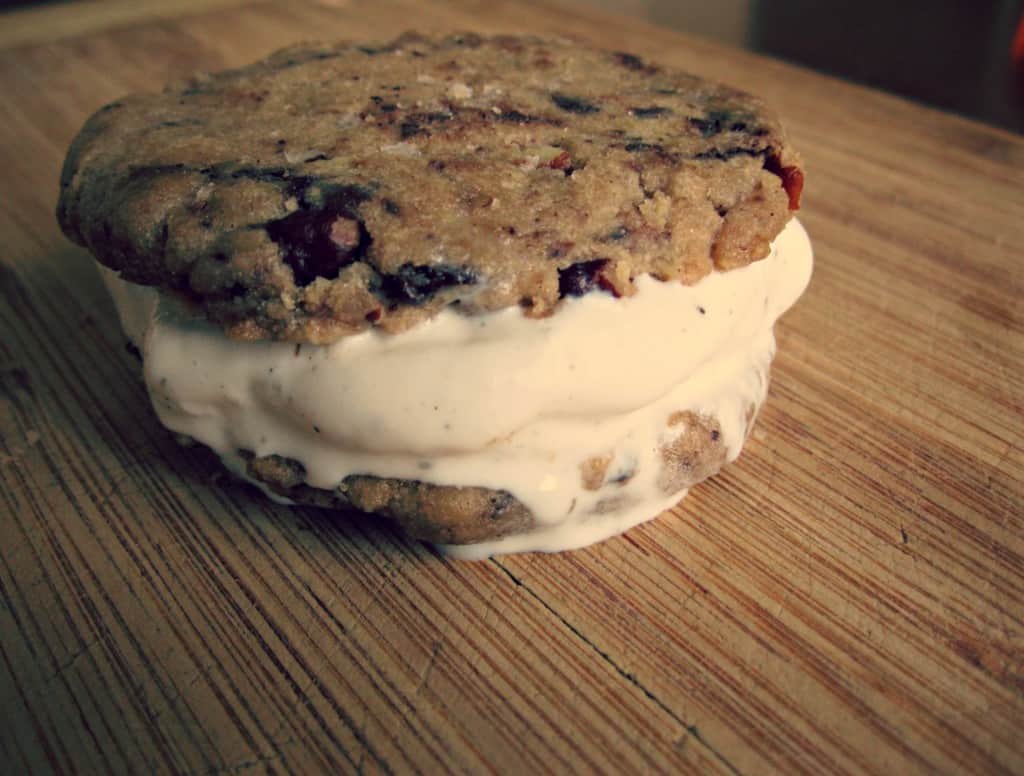 Two chocolate chip cookies made into an ice cream sandwich.