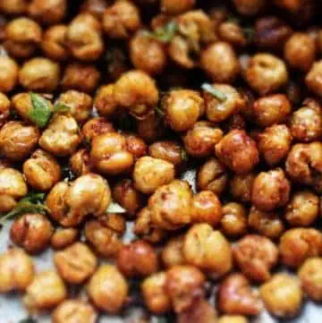 Crispy chick peas on a parchment lined baking sheet.