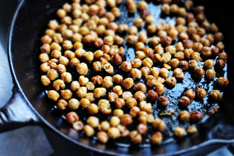 Top view of roasted chick peas in a cast iron skillet.