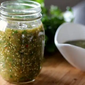 A pint mason jar filled with fresh salsa verde.