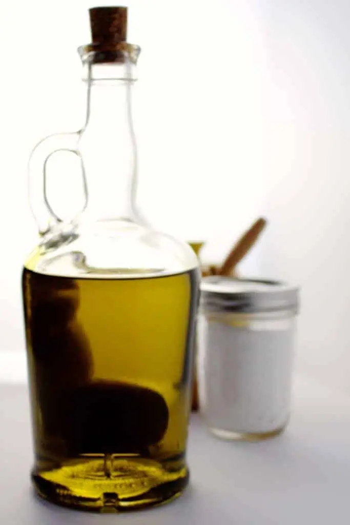 A glass carafe of olive oil on a counter.