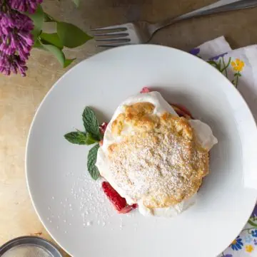 Top view of a strawberry rhubarb shortcake on a white plate.