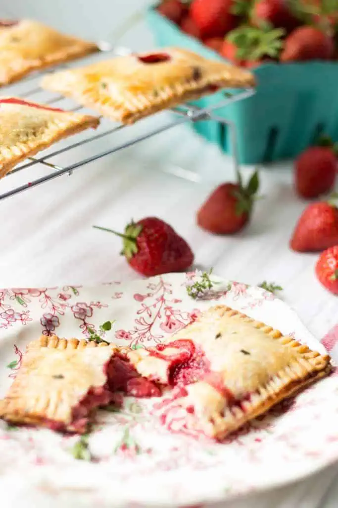 A strawberry goat cheese pop tart split in half on a plate.