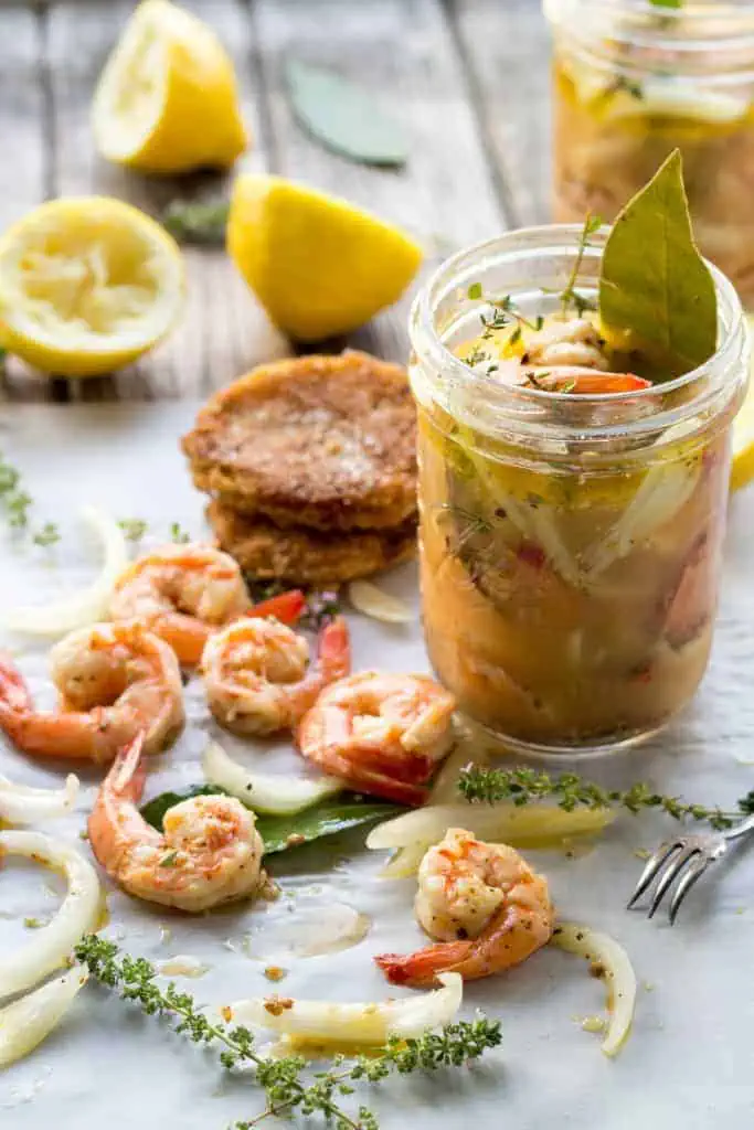 Shrimp and fried green tomatoes next to a jar of creole remoulade.