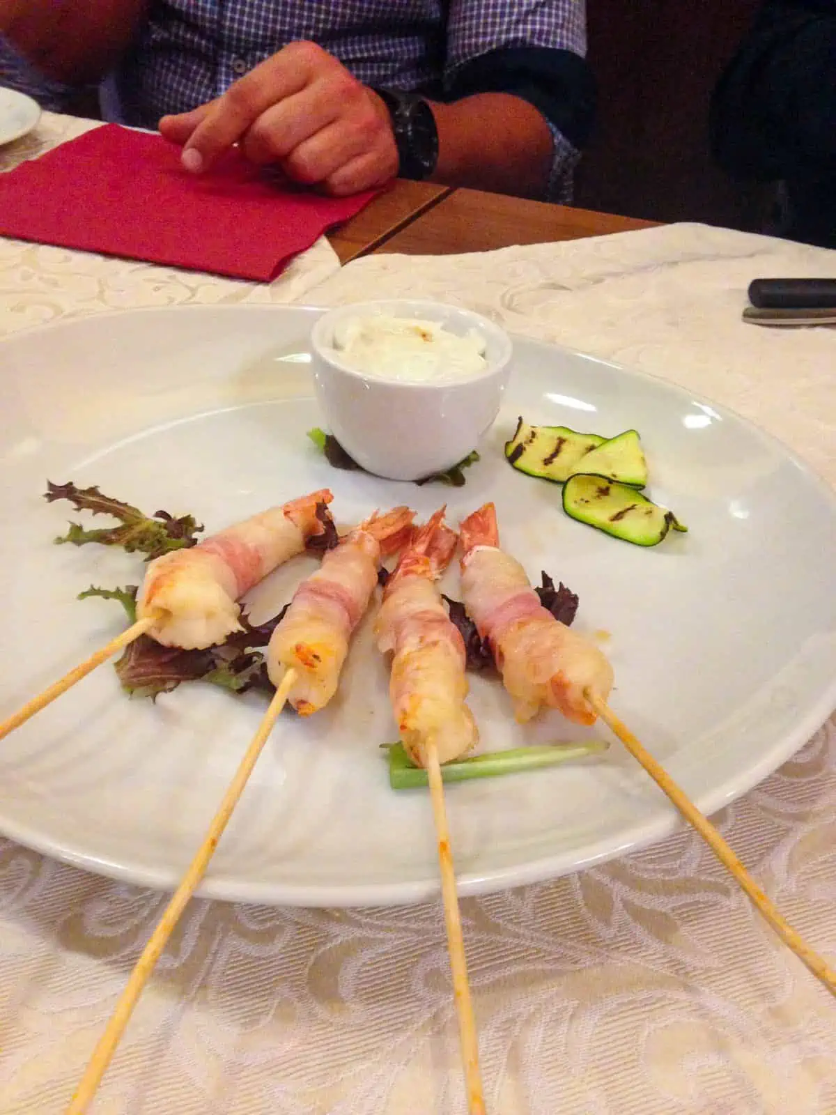 shrimp wrapped in lardo with gorgonzola sauce in Torino, Italy