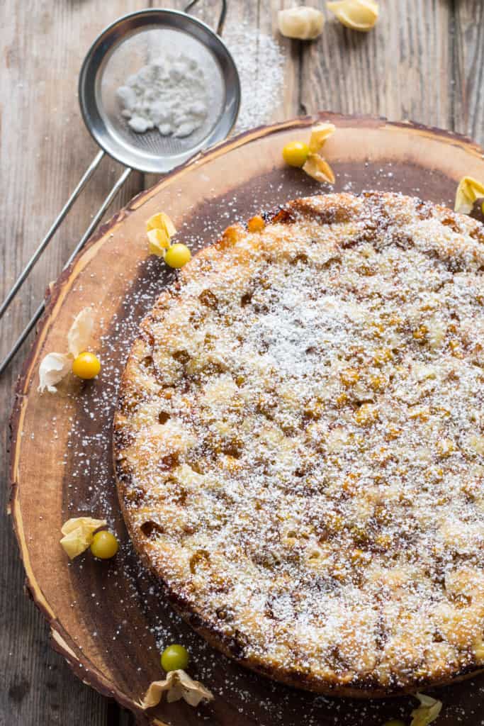 Top view of ground cherry torte on a wood board.