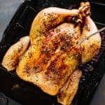 overhead shot of whole chicken in roasting pan