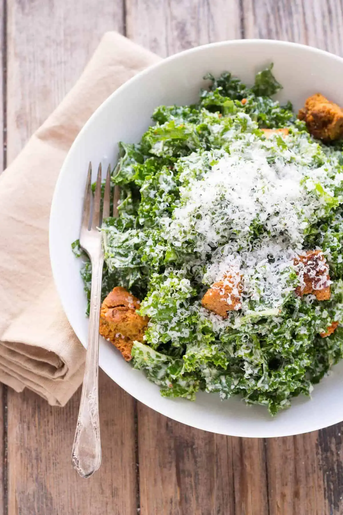 This easy recipe for Kale Caesar Salad is made with tender massaged kale and a traditional homemade Caesar dressing with anchovies.