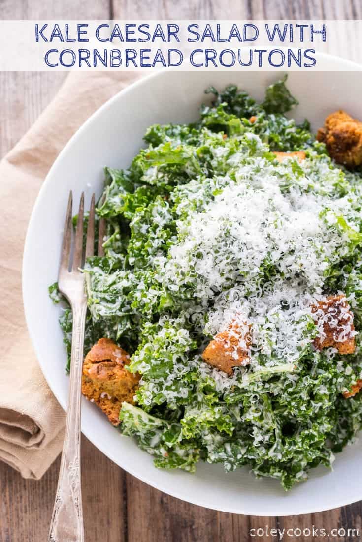 Top view of kale caesar salad covered with cheese and croutons.