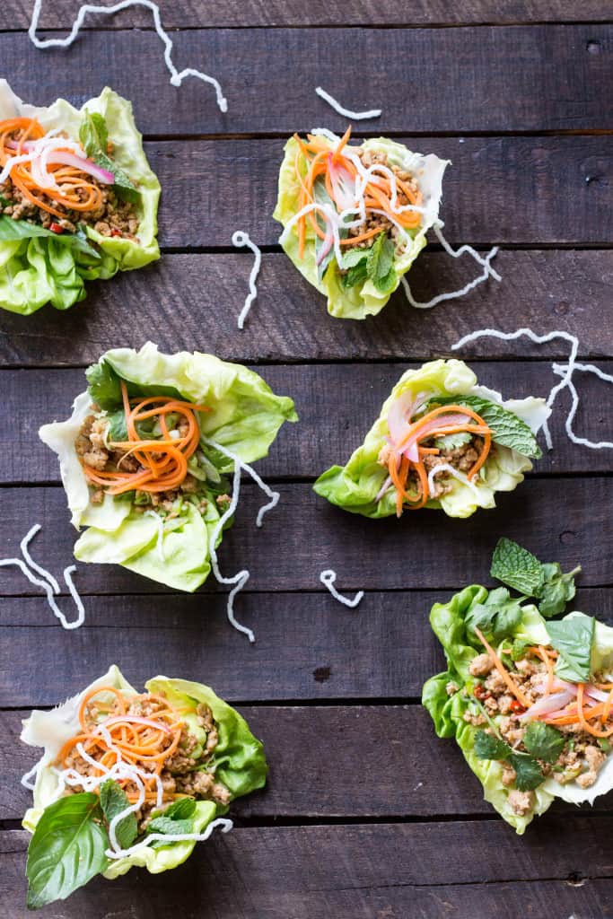 Half dozen lettuce cups filled with chicken and carrots.