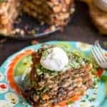 Top view of a slice of taco cake on a dinner plate.