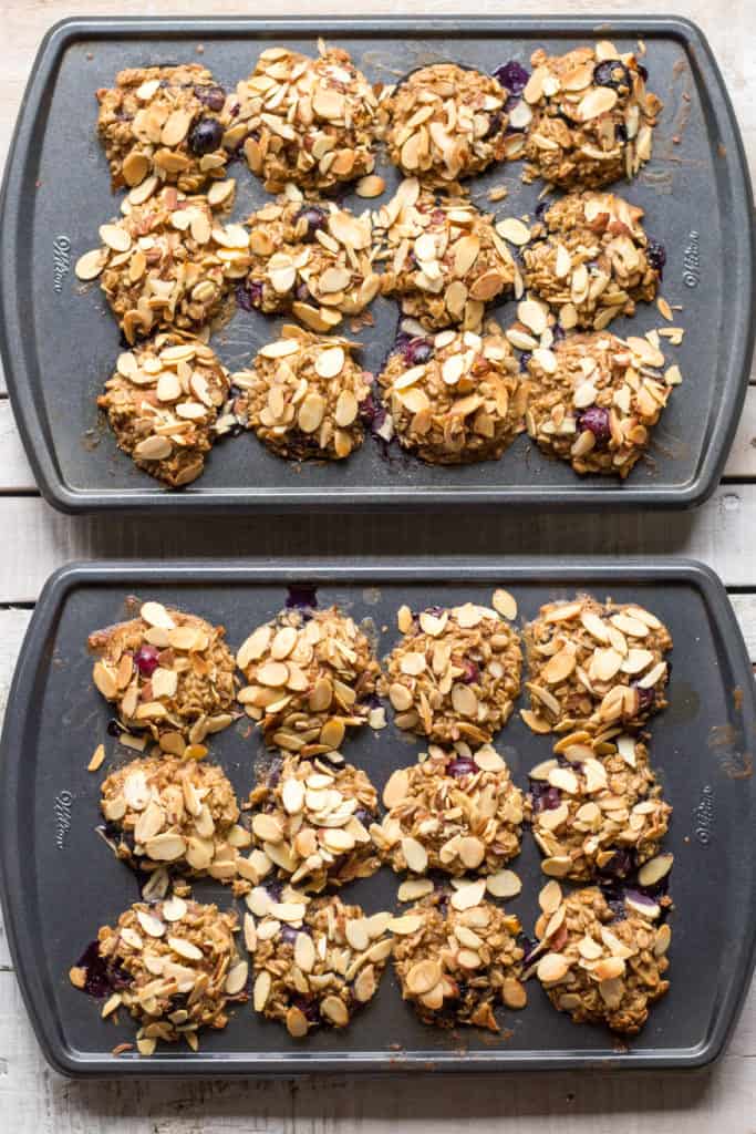 Two muffin tins filled with blueberry baked oatmeal cups.