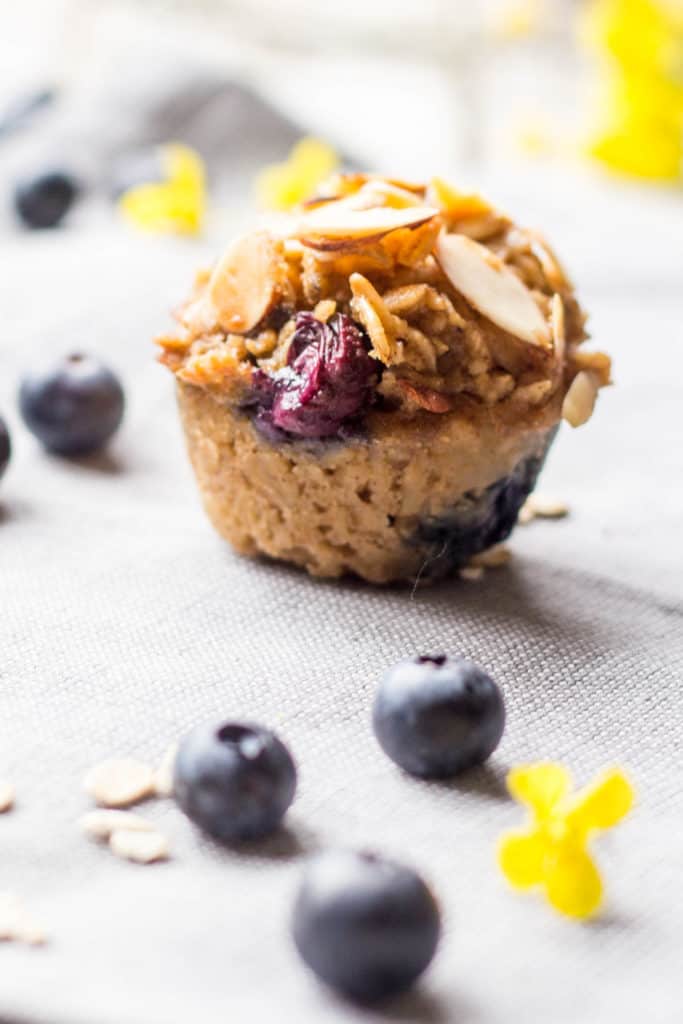 A close up of a single blueberry almond baked oatmeal cup on a cloth napkin.