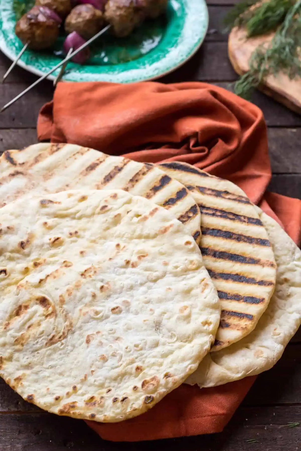 Grilled pita bread on a red napkin.
