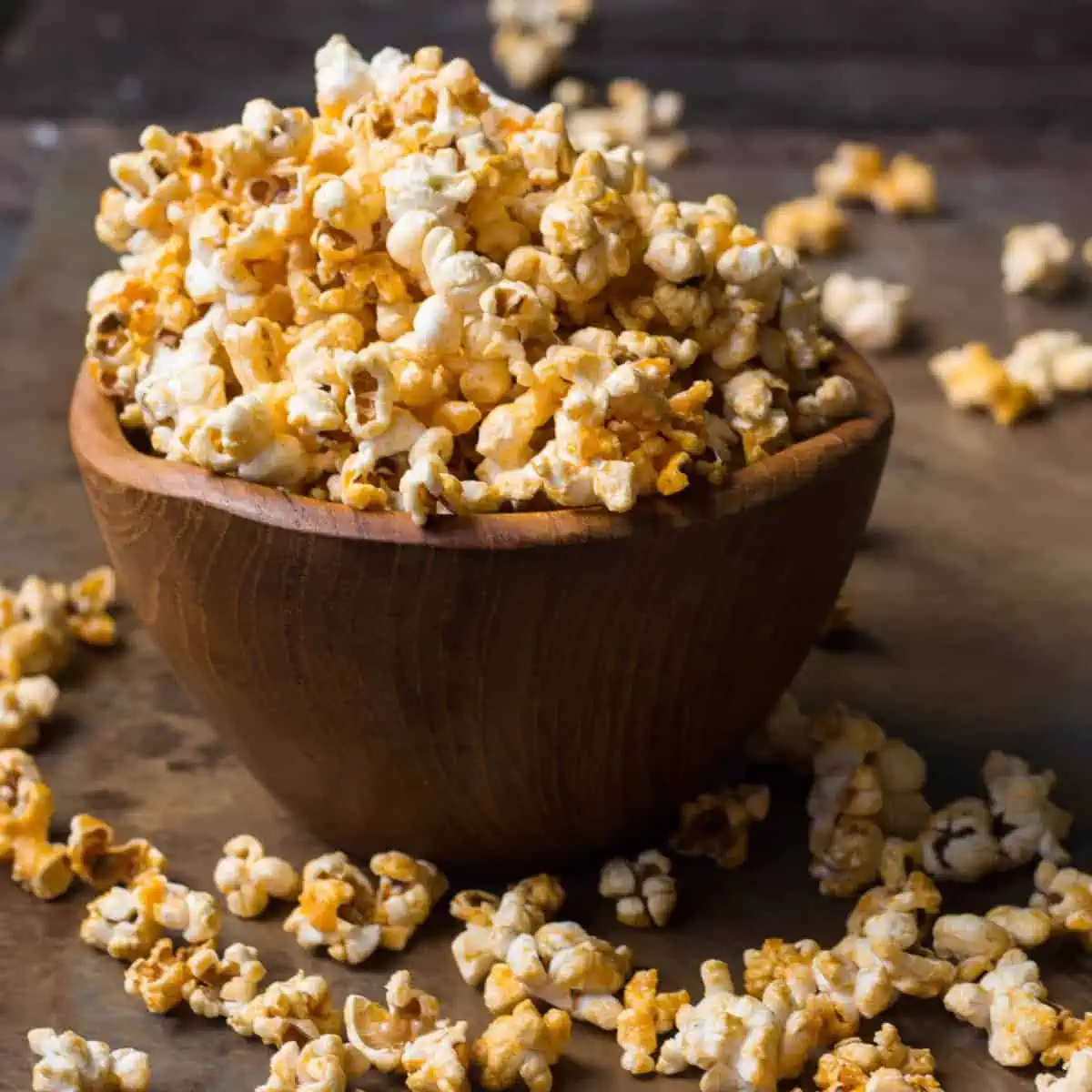 Popped corn in a small wooden bowl.