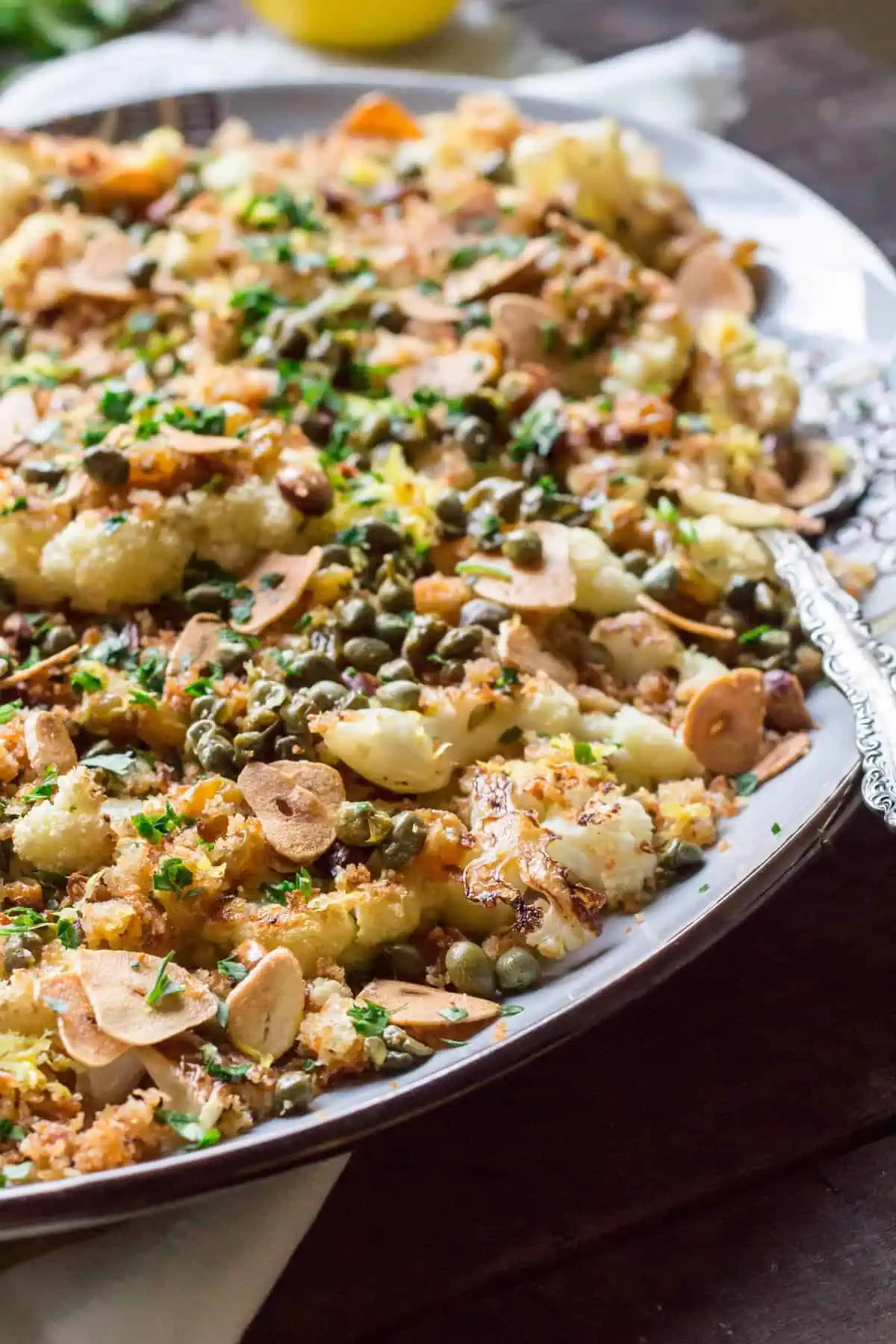 Close up of roasted cauliflower, toasted almonds, capers, and breadcrumbs.