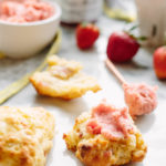 Freshly made strawberry butter spread on top of a prosciutto scone.