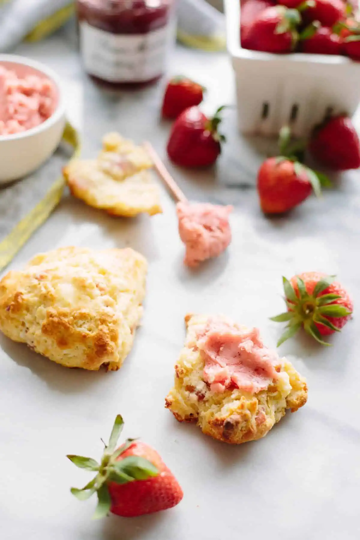 A split open scone spread with strawberry butter.