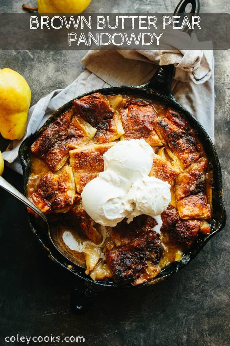 Top down view of a cast iron skillet with pear pandowdy that has vanilla ice cream on top.