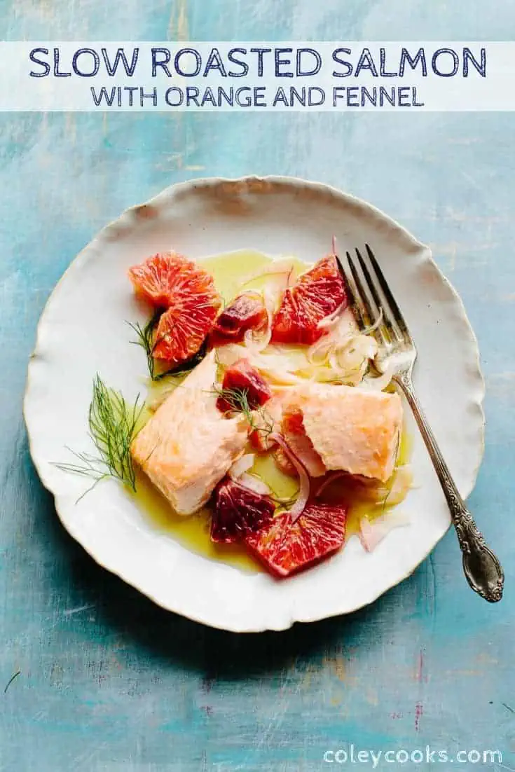 Top view of a white dinner plate with roasted citrus herb salmon.