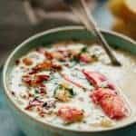 Close up view of a bowl of lobster clam chowder.