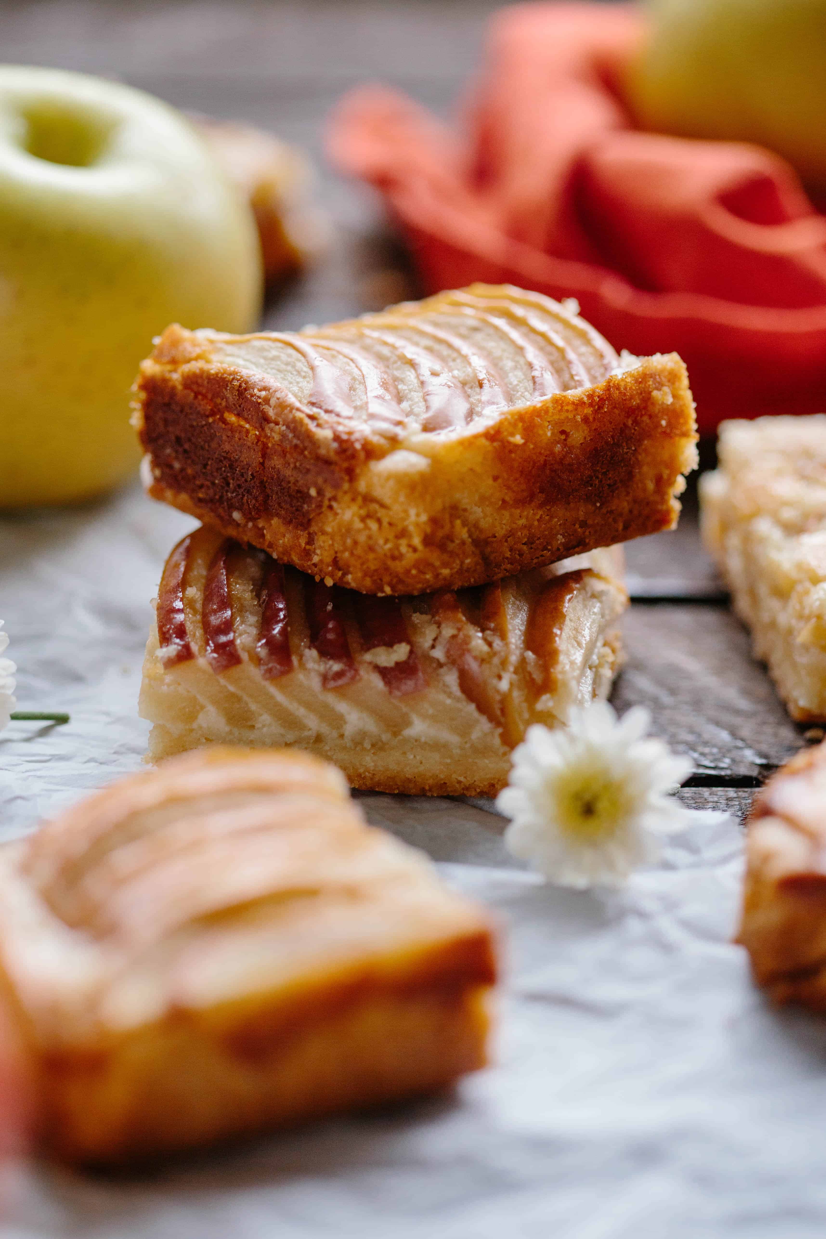 Close up shot of two apple almond shortbread bars stacked on top of each other.