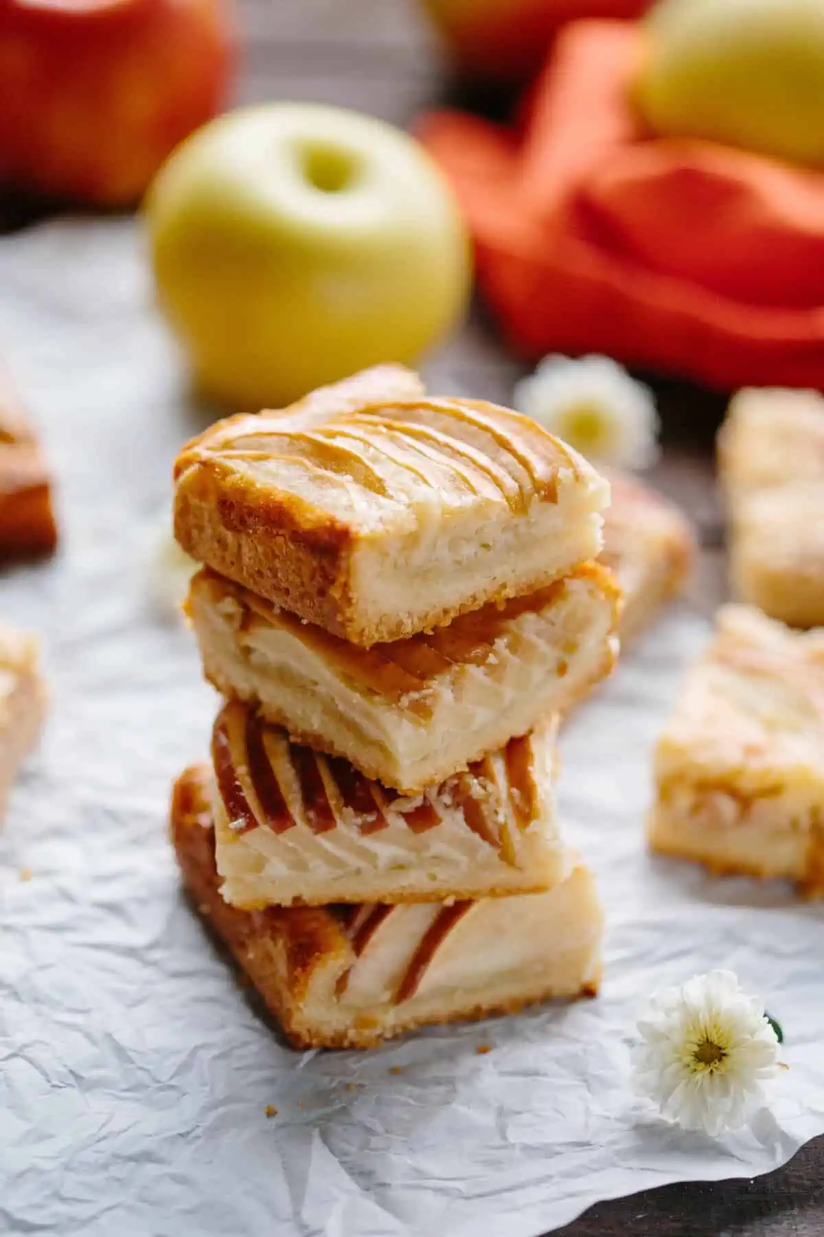 A vertical stack of four apple almond shortbread squares.
