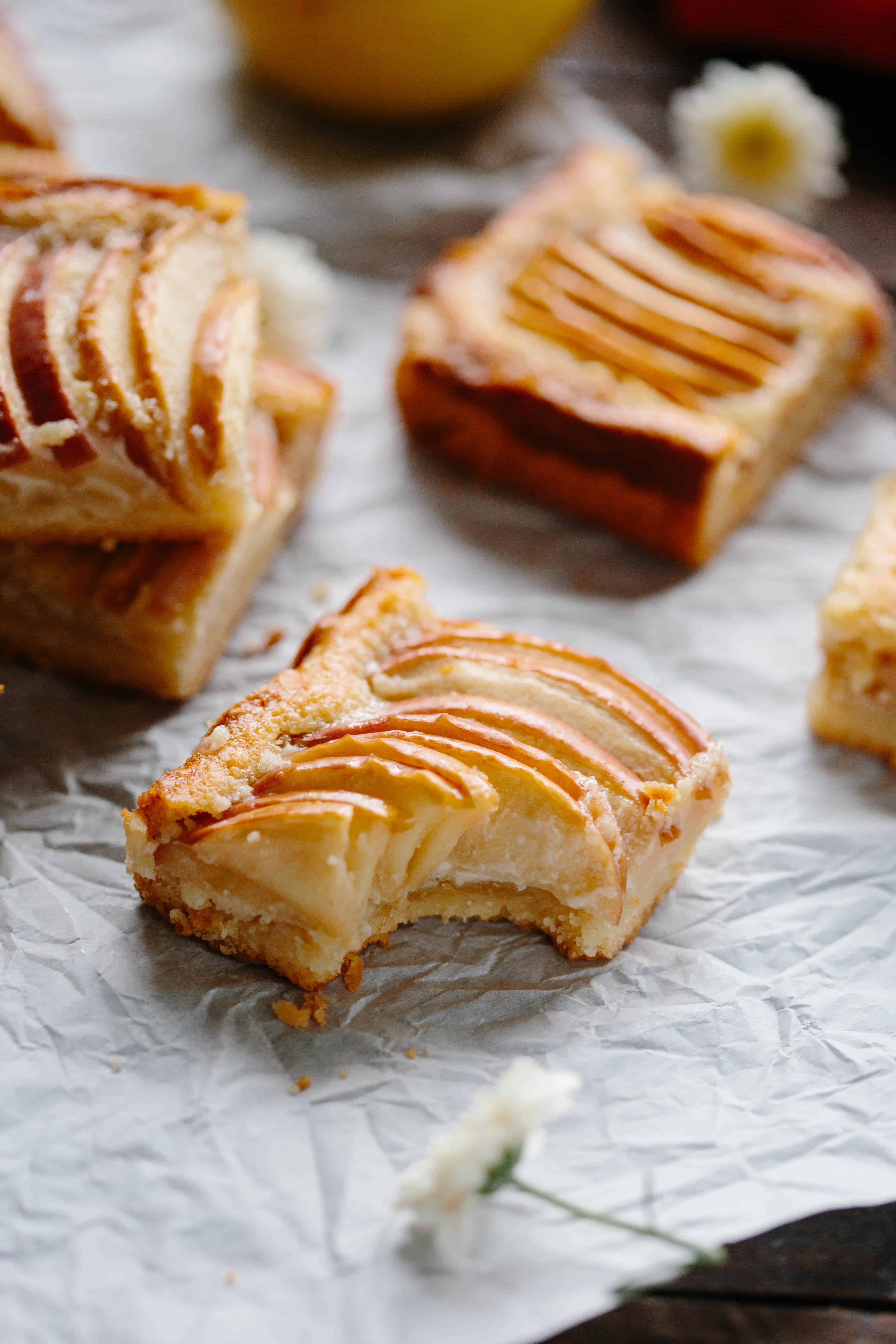 Apple almond shortbread slices on a sheet of parchment.