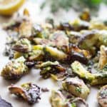 Crispy roasted Brussels sprouts on parchment paper.