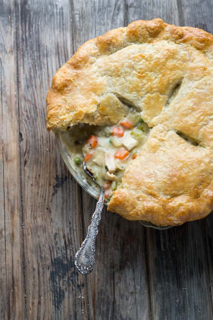 Top view of a chicken pot pie with a slice missing.