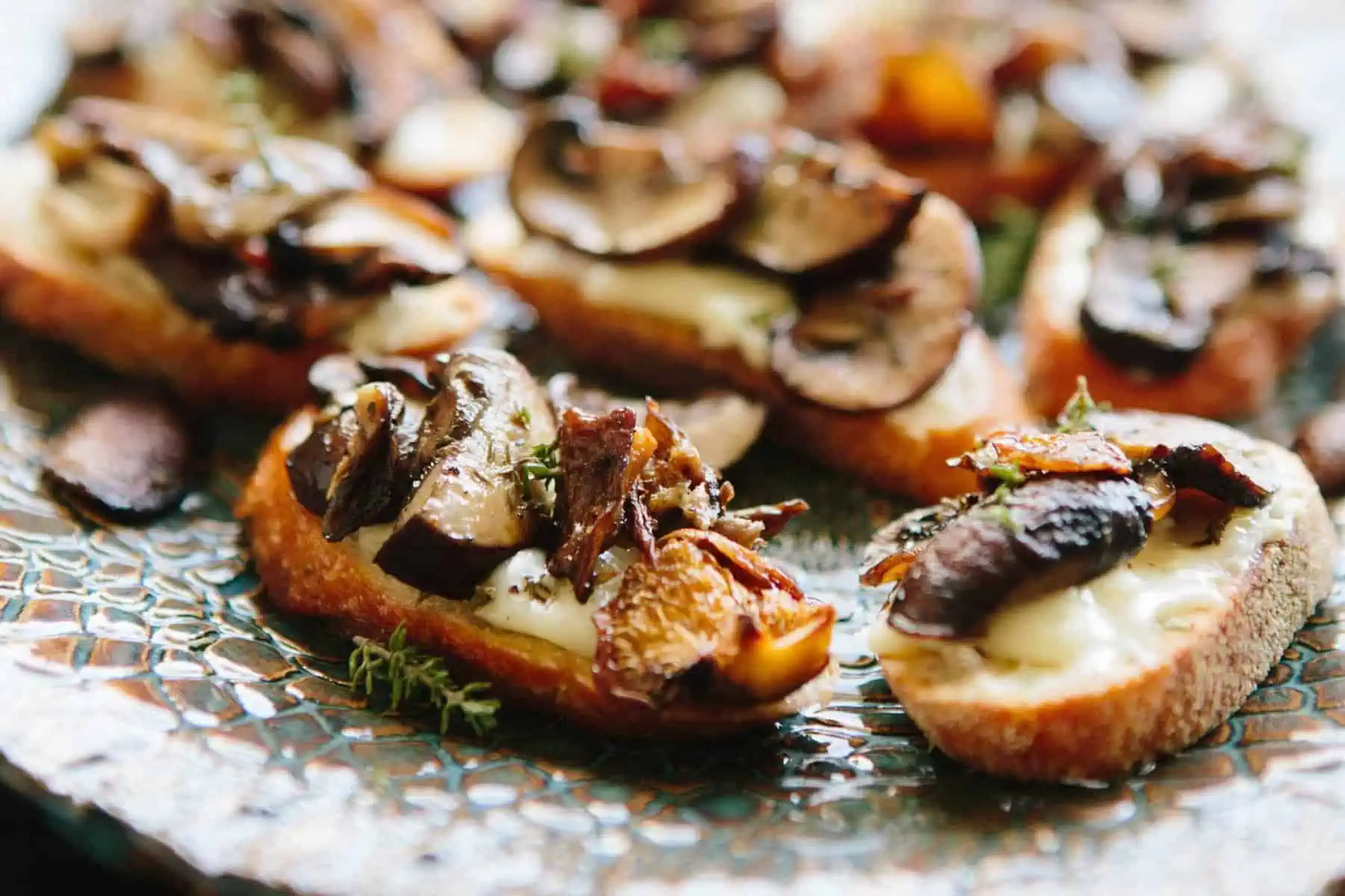 Close up of roasted mushrooms on crostini.