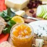 A jar of Meyer lemon marmalade in the middle of a charcuterie board.