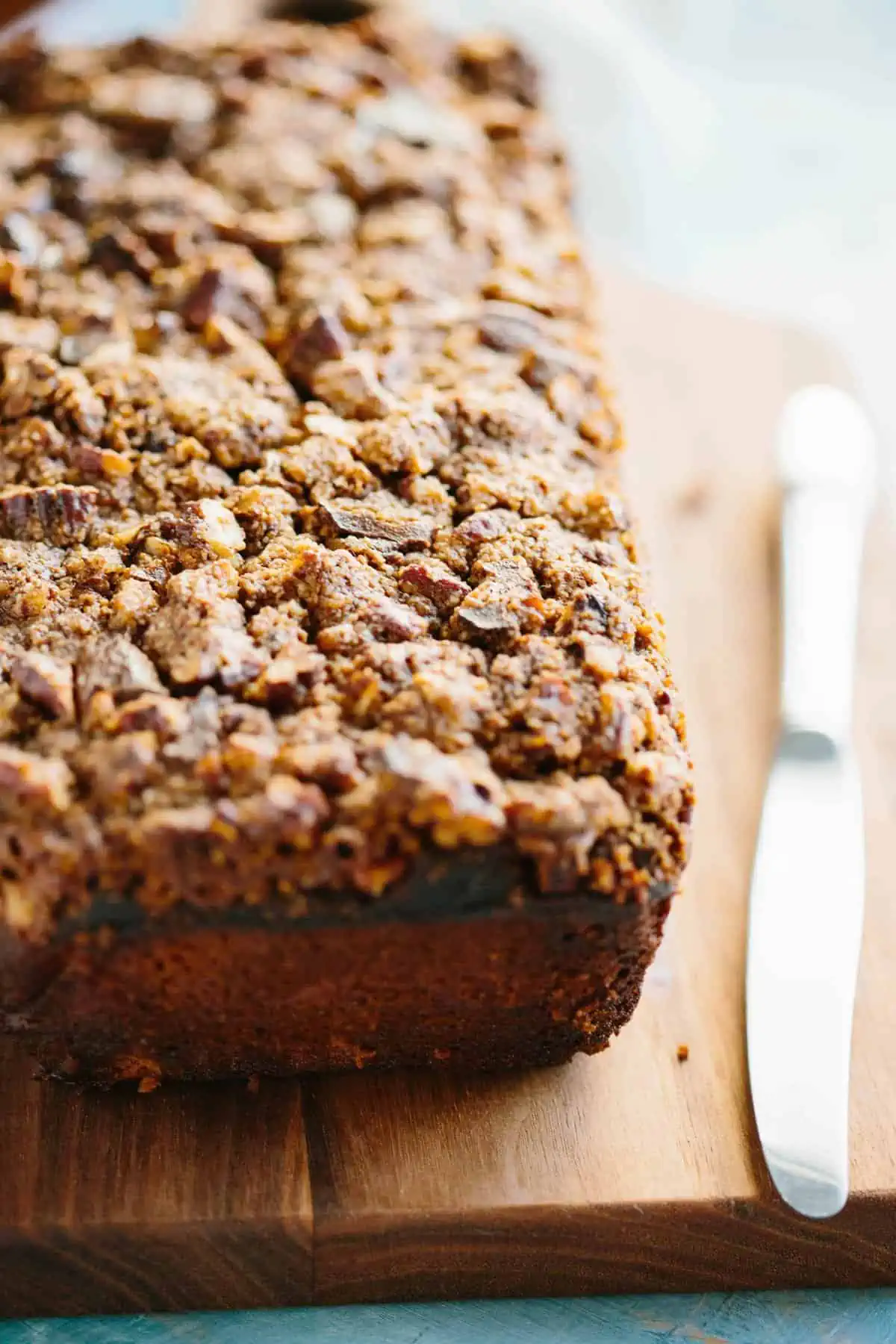 Close up end view of Paleo banana bread with pecan streusel topping.