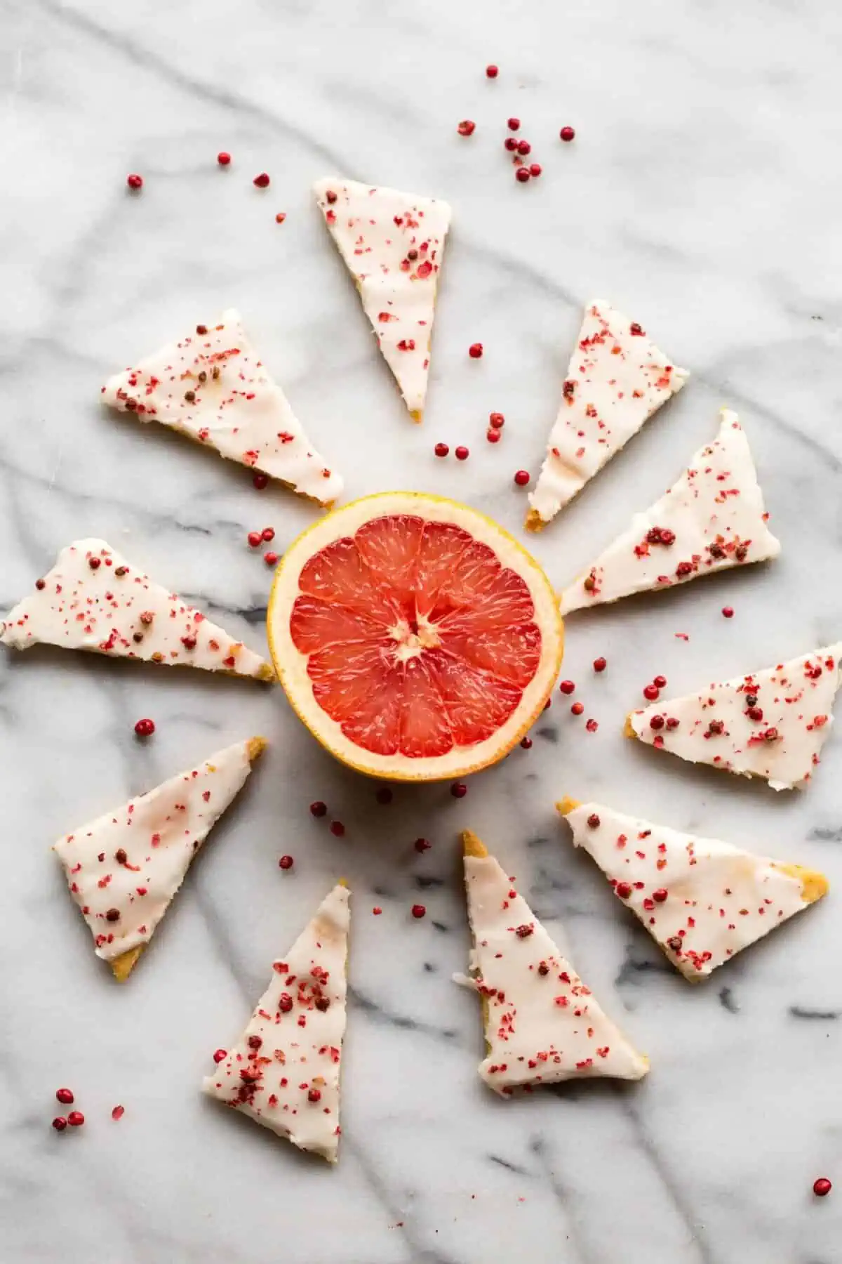 Pink grapefruit shortbread cookies cut in triangles.