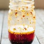 Glass jar filled with homemade chili oil.