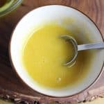 Olive oil and honey stirred together in a small bowl to use as a face mask.