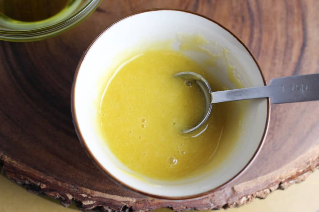 Olive oil and honey stirred together in a small bowl to use as a face mask.