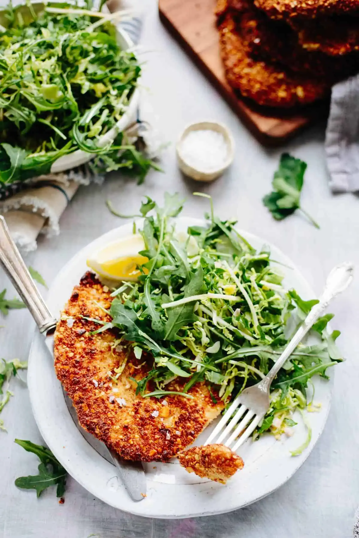 Almond Chicken Cutlets with Apple, Arugula + Brussels Sprout Salad. Gluten free, pan fried chicken cutlets, flavored with Dijon mustard and served with a crisp and refreshing apple, shaved Brussels sprout and arugula salad! #easy #chicken #cutlet #recipe #dijon #apple #brussels #salad #arugula #glutenfree #almond #crispy #healthy | ColeyCooks.com