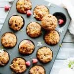 A dozen Paleo orange raspberry muffins baked in a muffin tin.