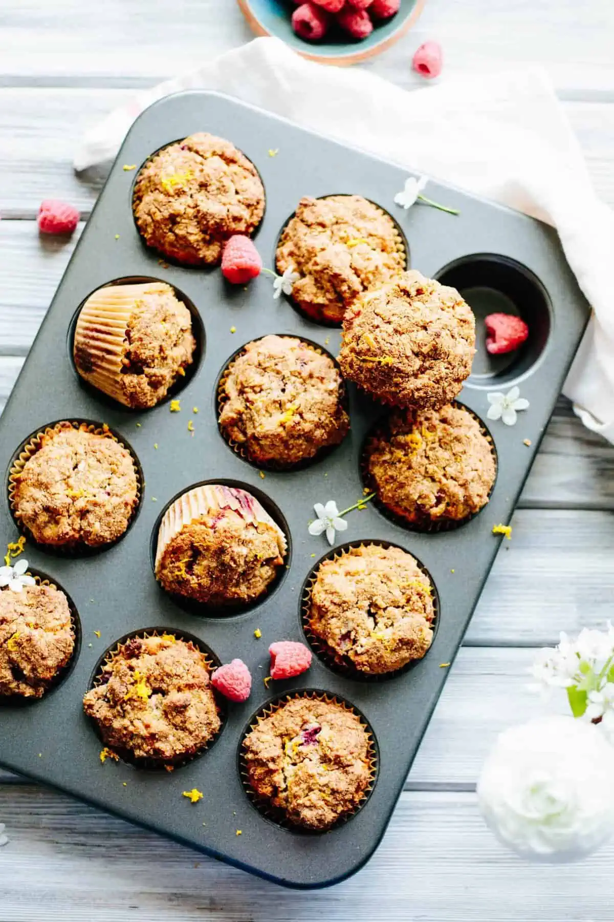 A dozen Paleo orange raspberry muffins baked in a muffin tin.