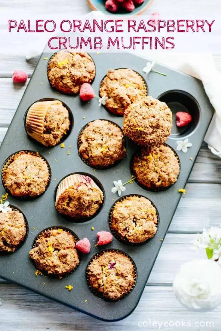 Muffin tin filled with baked Paleo orange raspberry crumb muffins.