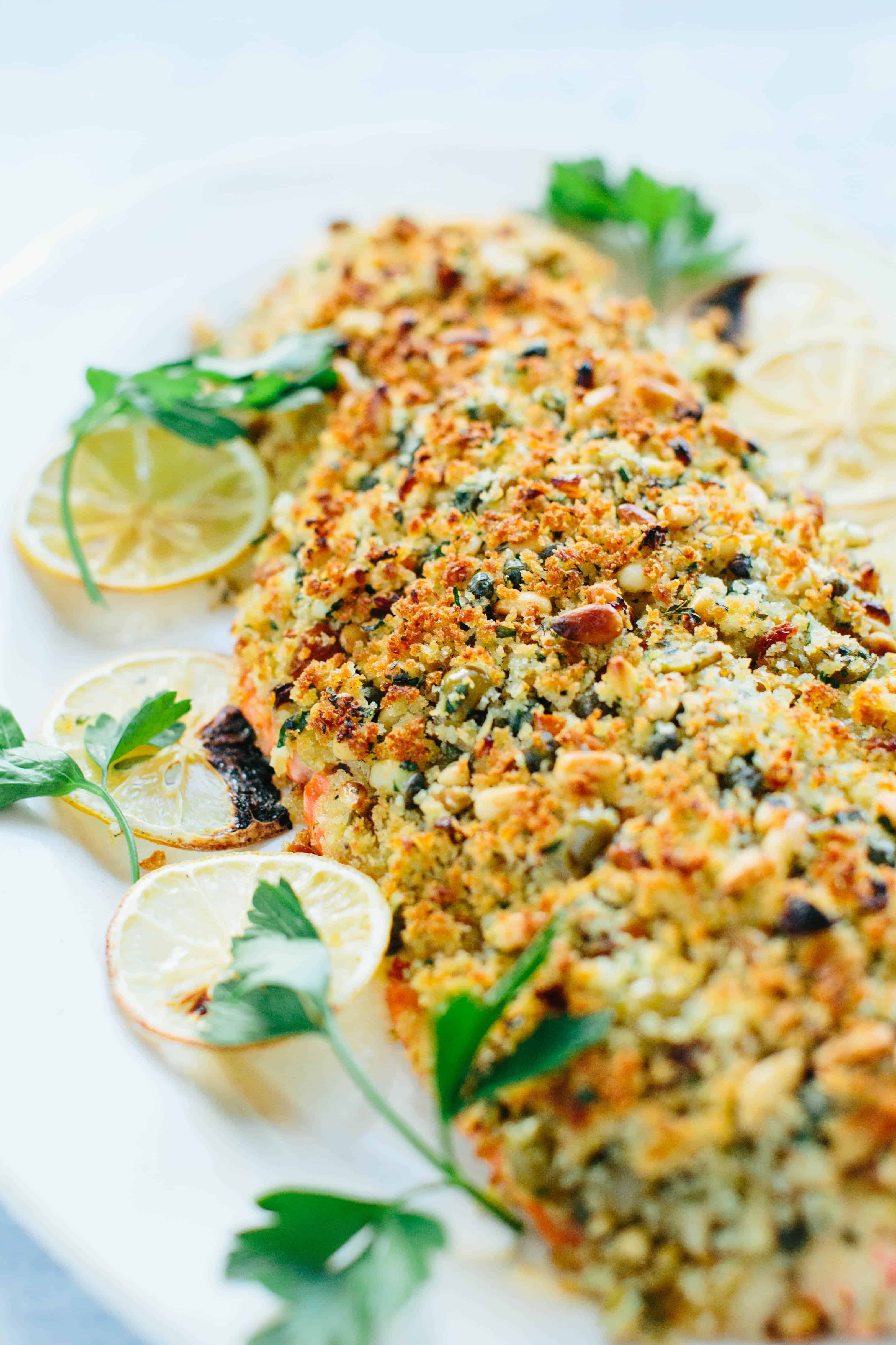 A close up of Sicilian baked salmon with lemons and parsley