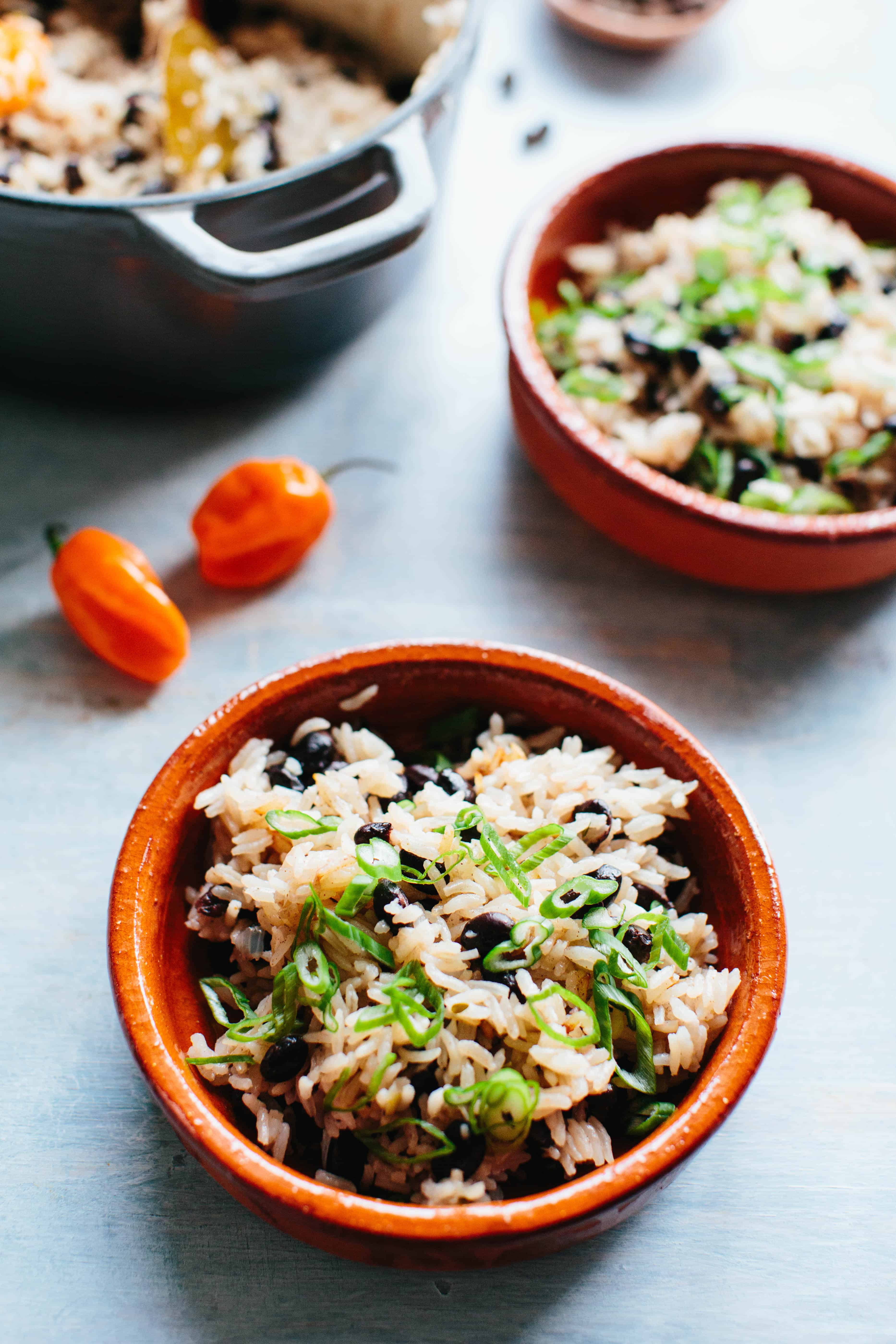 A bowl black beans and rice with scallions 