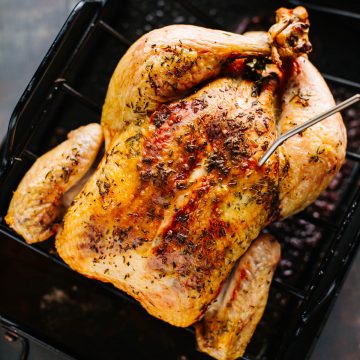 overhead shot of whole chicken in roasting pan