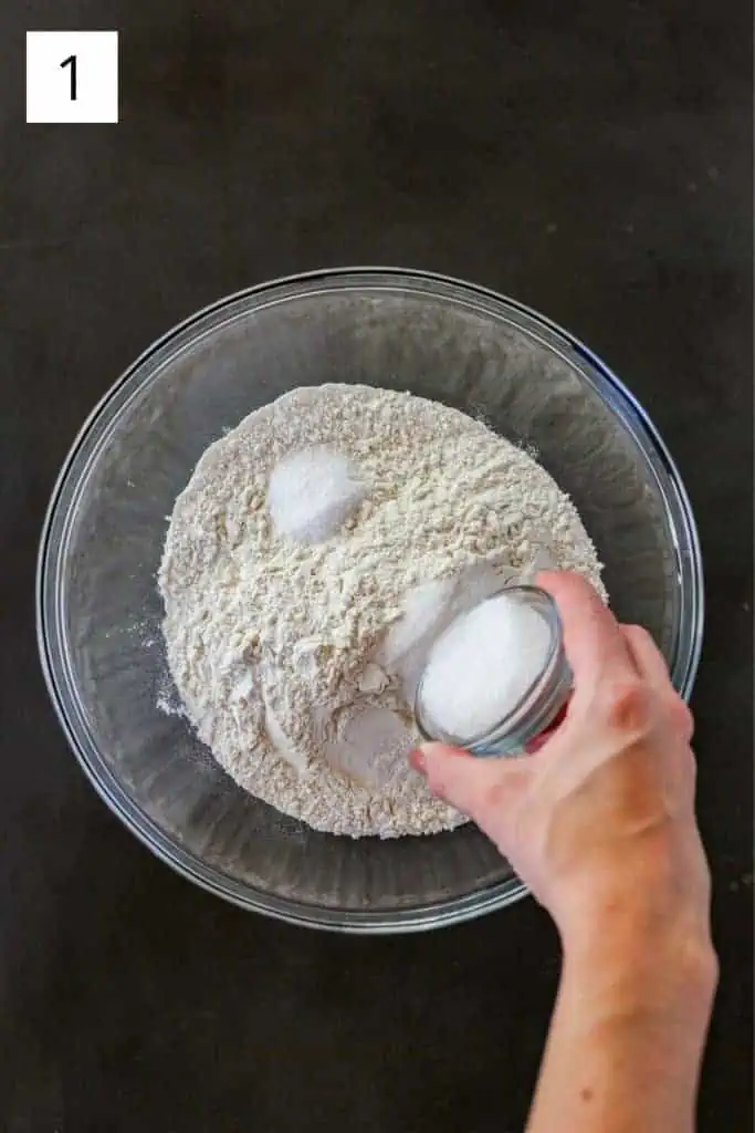 hand pouring sugar into a bowl with salt and flour