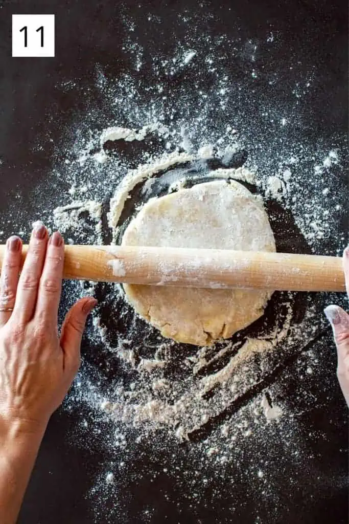 hands rolling a rolling pin over a disc of pie dough
