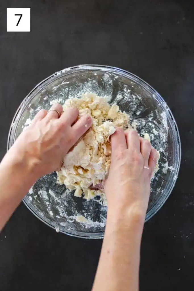hands mixing pie dough