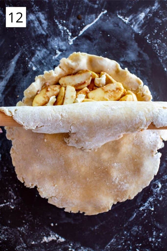 rolling the top pie crust over the filling