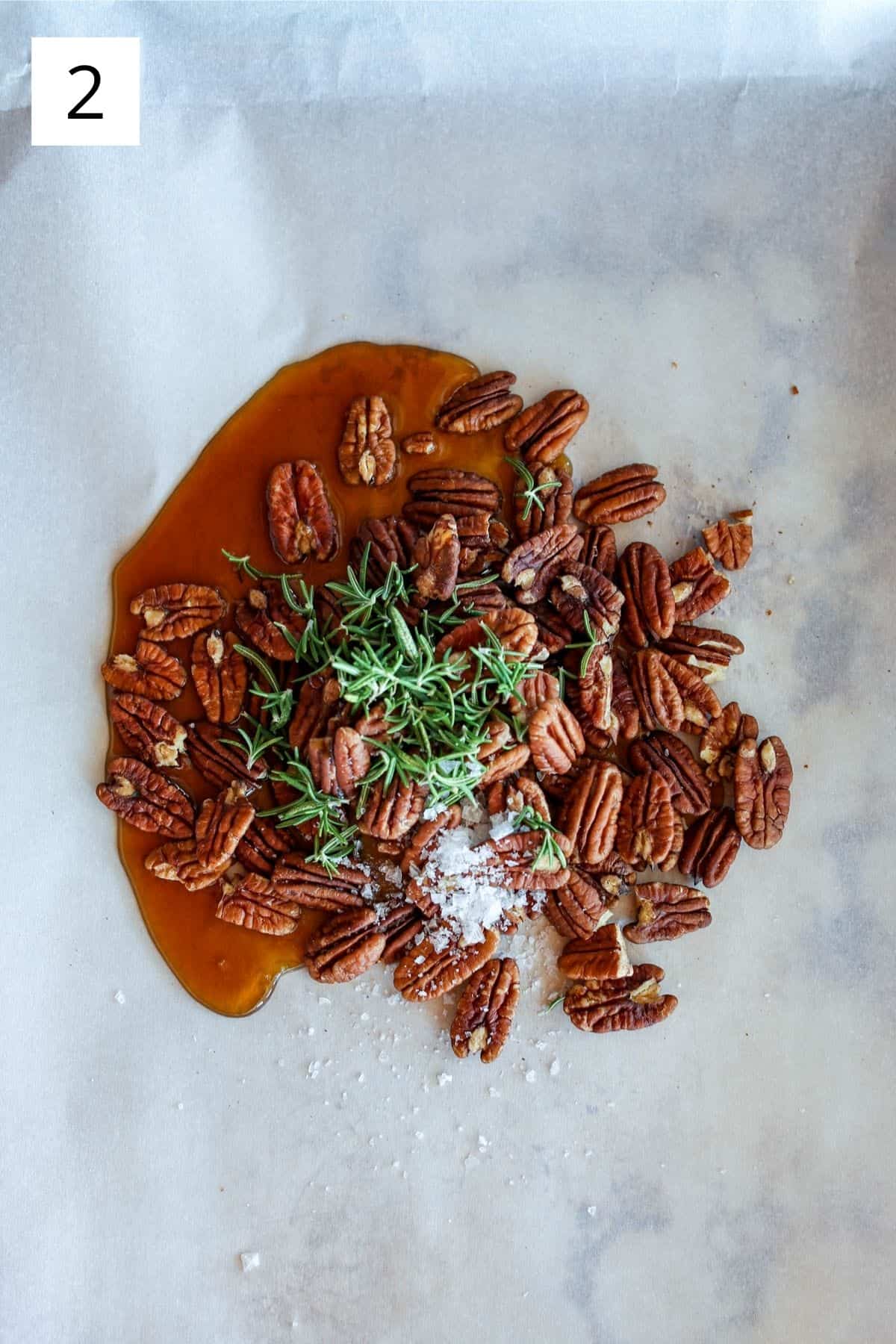 pecans, rosemary, sea salt and maple syrup on a sheet pan