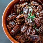 close up of a bowl of rosemary maple roasted pecans
